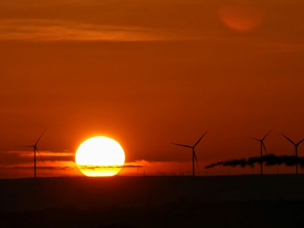 Sunset over a wind farm in the Arab region, highlighting renewable energy efforts.