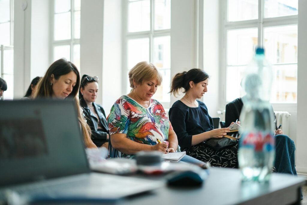A lively group of people participating in a hands-on training session in a bright, welcoming room.