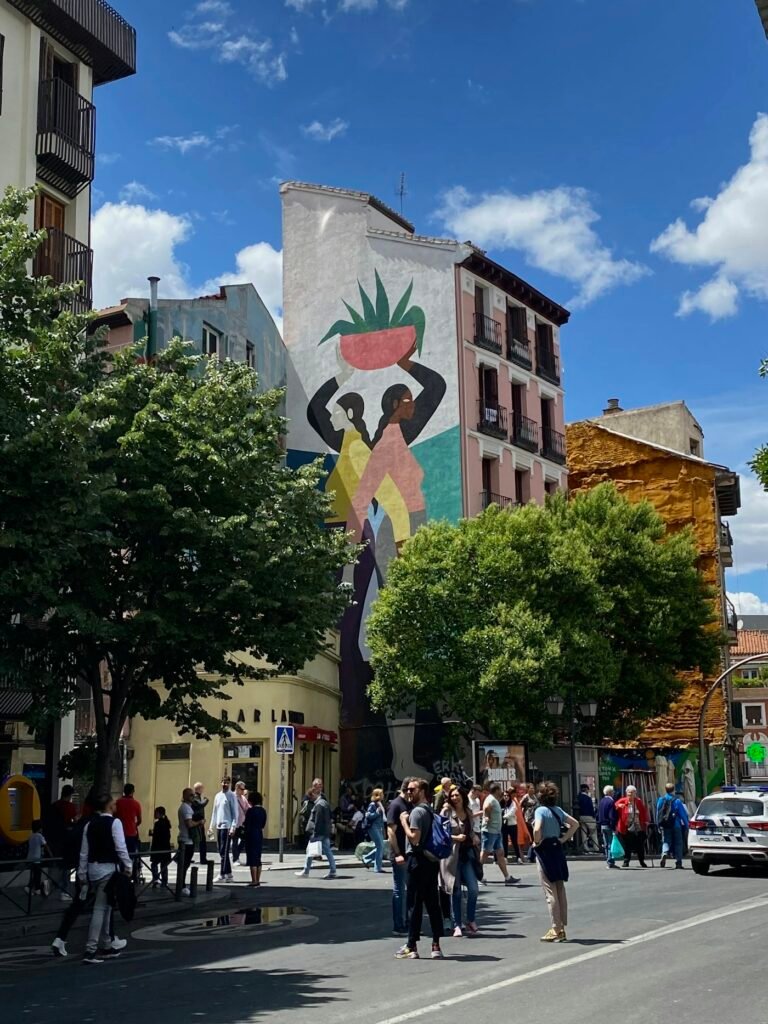 A vibrant street mural depicting the Arab world united for climate action under a clear blue sky.